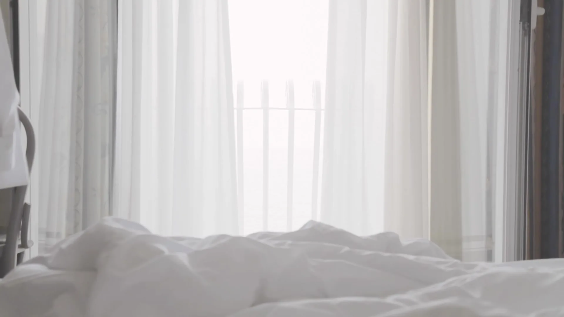 Sheer curtains beside a bedroom window